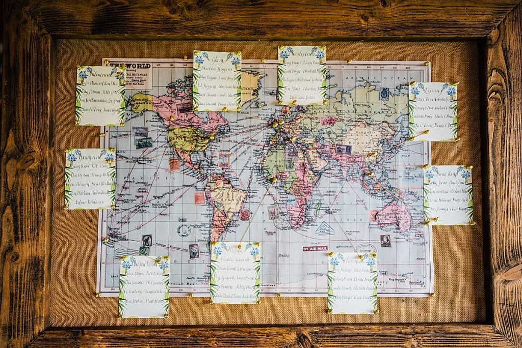 travel themed wedding table plan in wooden frame taken by Parrot & Pineapple Wedding Photography