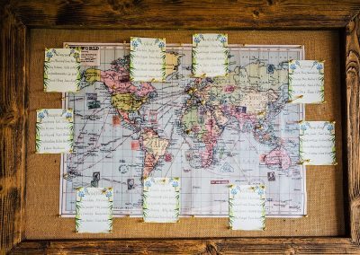 travel themed wedding table plan in wooden frame taken by Parrot & Pineapple Wedding Photography