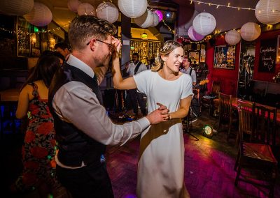 bride and groom dance together at fun wedding party at the londesborough in east london