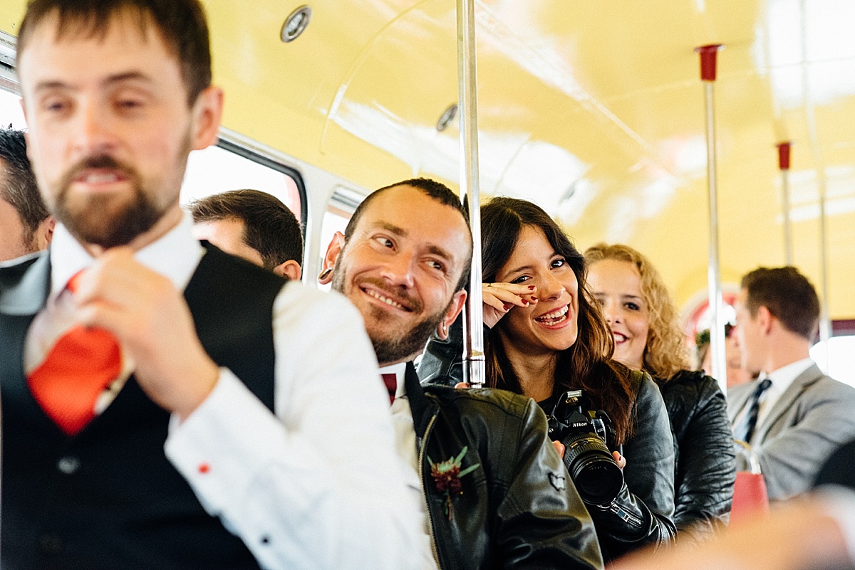 wedding guest sitting on vintage bus taken by Parrot & Pineapple Wedding Photography
