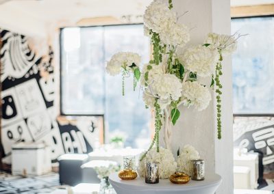 White hydrangea floral arrangement at warehouse wedding. Image by Parrot and Pineapple.