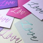 Wedding Invites with purple cards and italic "love" from Lucky Ink Wedding Stationers