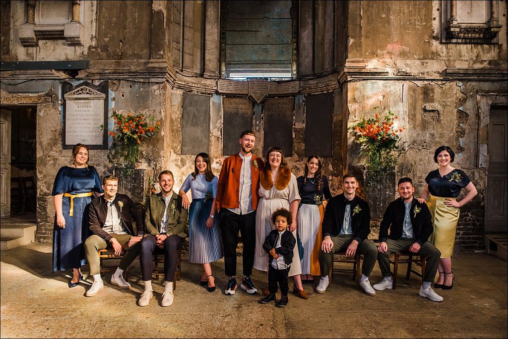 Bride groom and wedding party pose for a group photo at The Asylum in London.