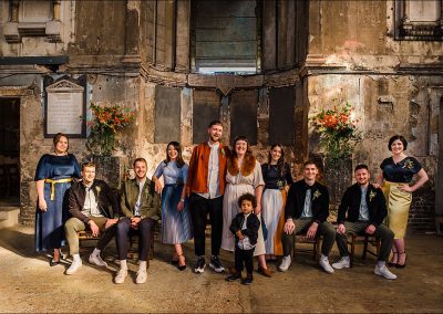 Bride groom and wedding party pose for a group photo at The Asylum in London.
