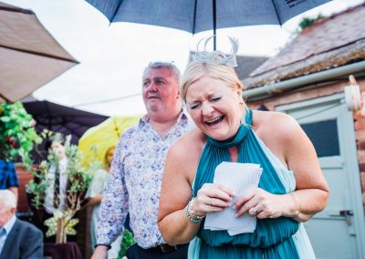 Bride and groom cutting cake small wedding