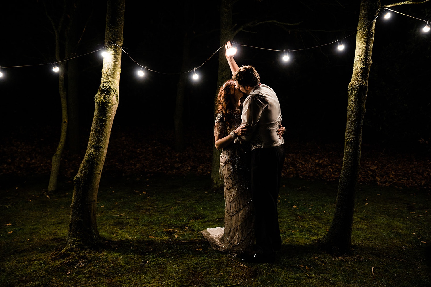 bride and groom under lights Shustoke Barn wedding