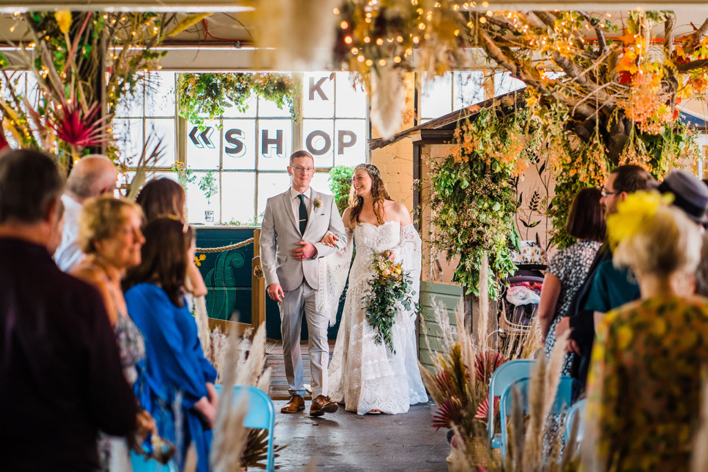 Bride and groom walk in to wedding ceremony at The Hideaway wedding venue in Sheffield