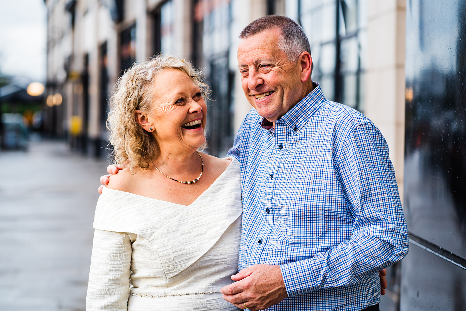 Bride and groom stand outside The Showroom Cinema in Sheffield after having got married at The Workstation